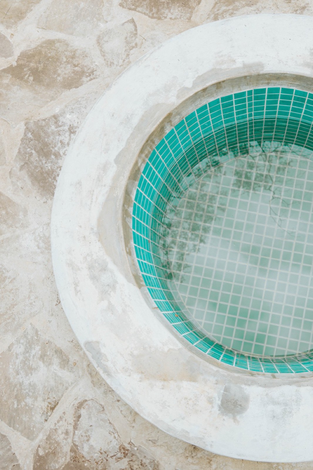 Green-tile cold plunge pool beside the temazcal at Kantu